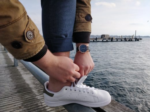 man tying shoelaces wearing chase west usa watch